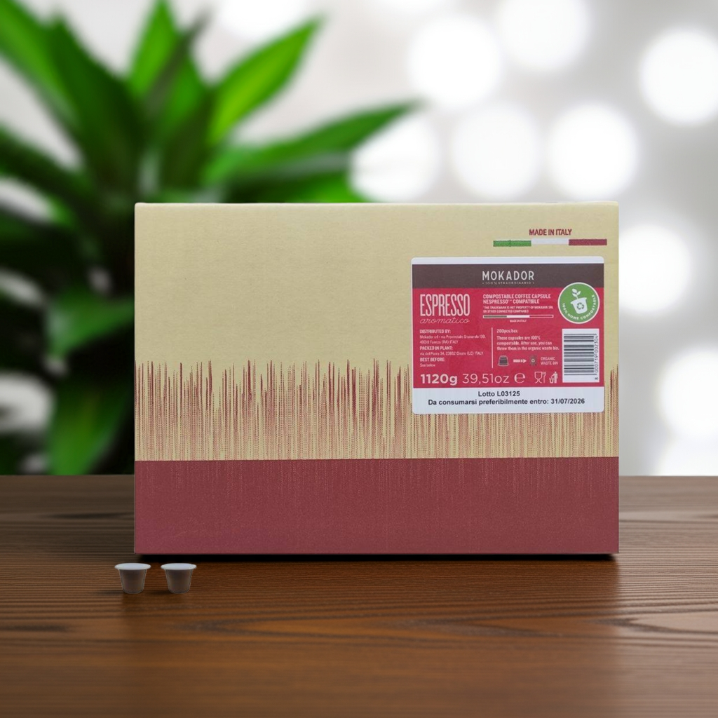 Mokador Espresso coffee packaging on a wooden surface with a blurred plant in the background