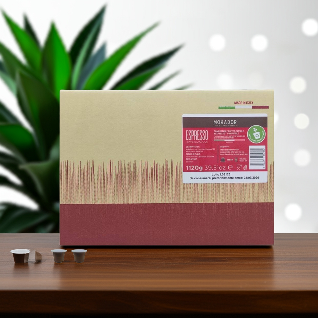 Mokador espresso packaging on a wooden surface with a plant in the background