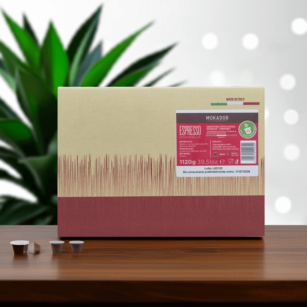 Mokador espresso packaging on a wooden surface with a plant in the background
