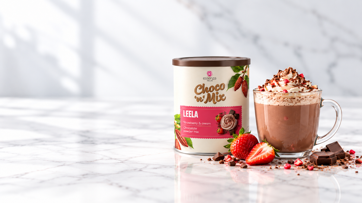 A Strawberry and Cream hot chocolate, palm oil drink mix stands on a white marble surface next to a glass mug filled with chocolate milk, topped with whipped cream, Buy online in Ireland at Fzin Coffee